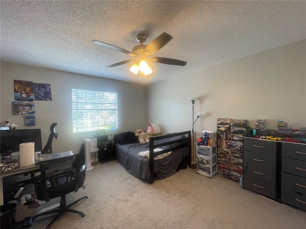 6980 Ulmerton Road, Unit 3G Largo, FL 33771 - Photo 28 of 52 a living room with furniture a ceiling fan and a window