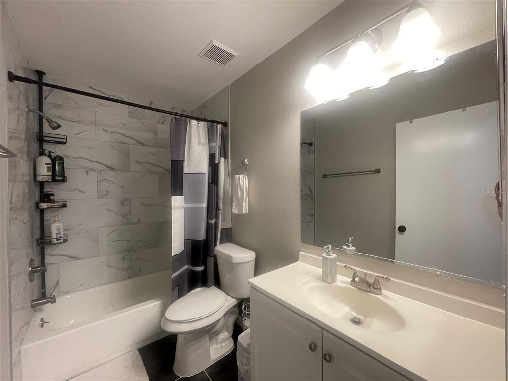 6980 Ulmerton Road, Unit 3G Largo, FL 33771 - Photo 30 of 52 a bathroom with a sink toilet and shower