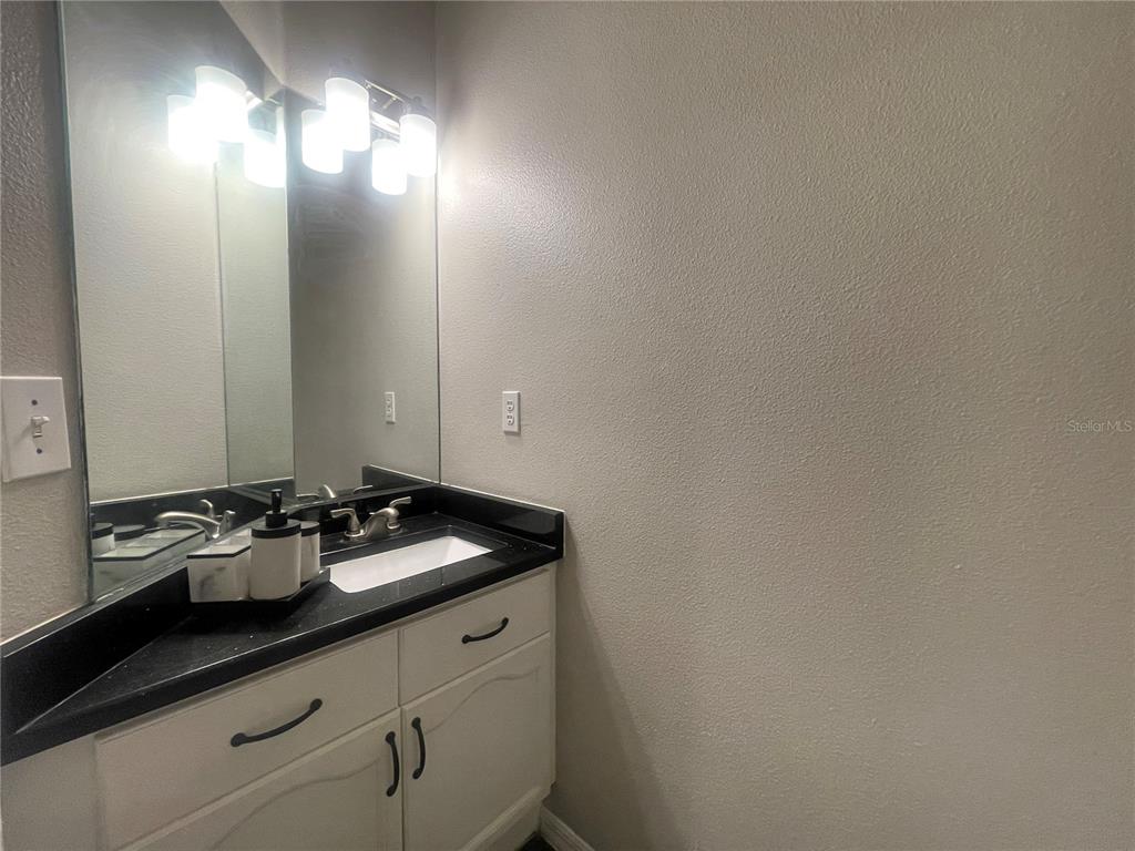 6980 Ulmerton Road, Unit 3G Largo, FL 33771 - Photo 31 of 52 a bathroom with a sink and a mirror