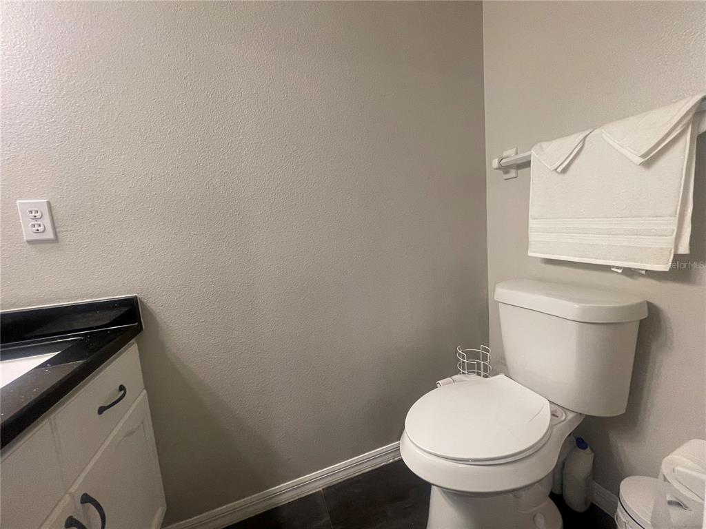 6980 Ulmerton Road, Unit 3G Largo, FL 33771 - Photo 32 of 52 a white toilet sitting next to a bathroom sink