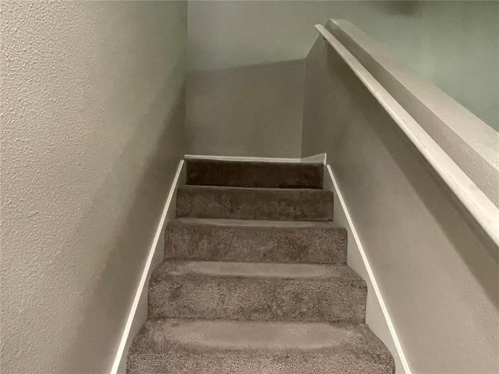 6980 Ulmerton Road, Unit 3G Largo, FL 33771 - Photo 35 of 52 a view of staircase with white walls
