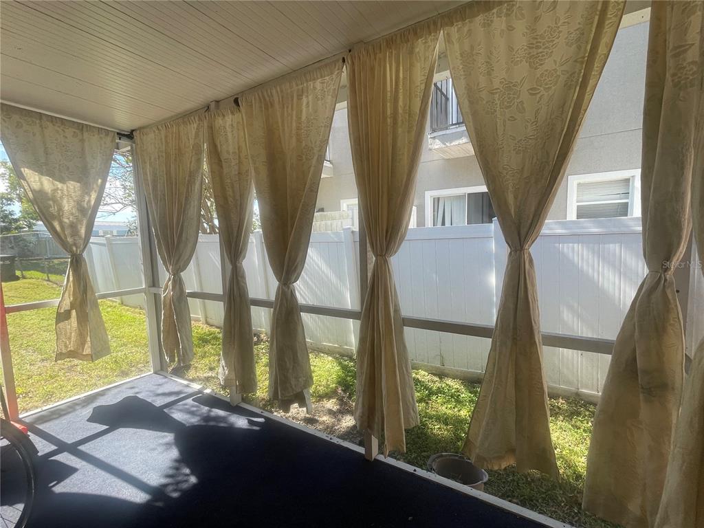 6980 Ulmerton Road, Unit 3G Largo, FL 33771 - Photo 40 of 52 a living room with large windows and a table