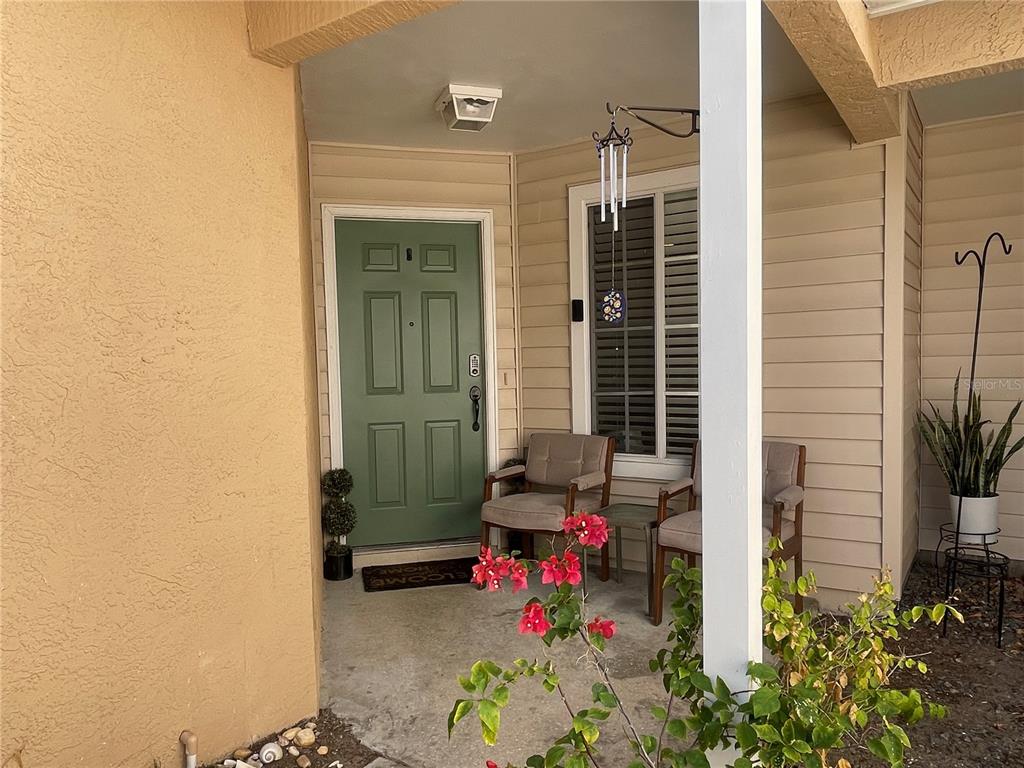6980 Ulmerton Road, Unit 3G Largo, FL 33771 - Photo 4 of 52 a view of a porch with a table and chairs