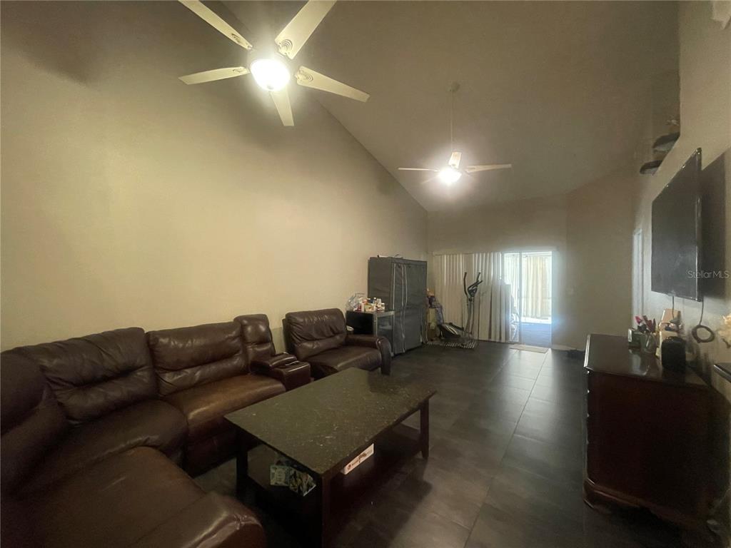 6980 Ulmerton Road, Unit 3G Largo, FL 33771 - Photo 5 of 52 a living room with furniture and a chandelier