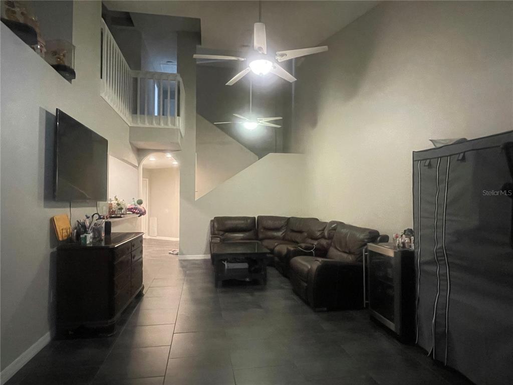 6980 Ulmerton Road, Unit 3G Largo, FL 33771 - Photo 7 of 52 a living room with furniture and a flat screen tv