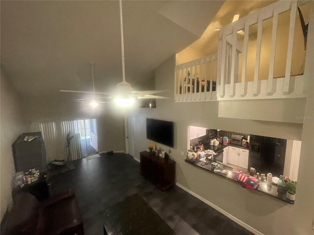 6980 Ulmerton Road, Unit 3G Largo, FL 33771 - Photo 9 of 52 a living room with furniture fireplace and flat screen tv