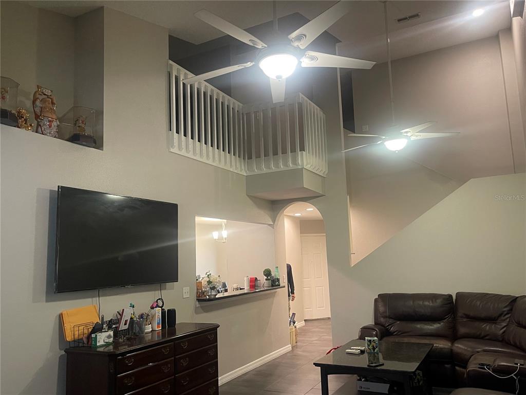 6980 Ulmerton Road, Unit 3G Largo, FL 33771 - Photo 10 of 52 a living room with furniture and a flat screen tv