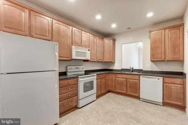 a white refrigerator freezer sitting inside of a kitchen