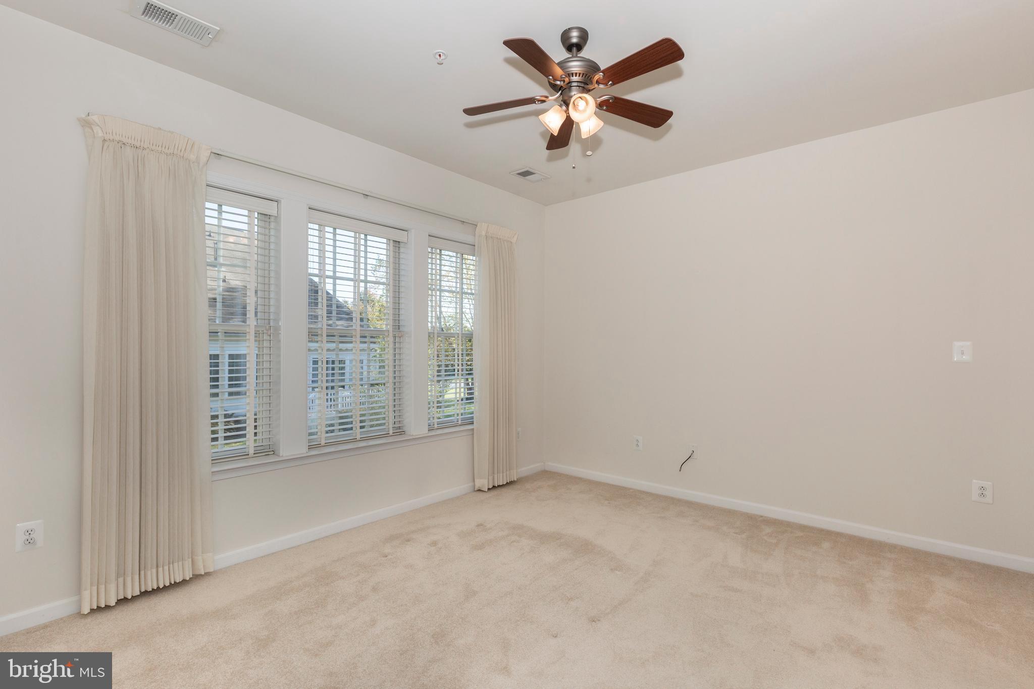172 Saddletop Drive, Unit 364 Taneytown, MD 21787 - Photo 24 of 38 an empty room with windows and ceiling fan