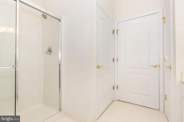 a bathroom with a glass shower door
