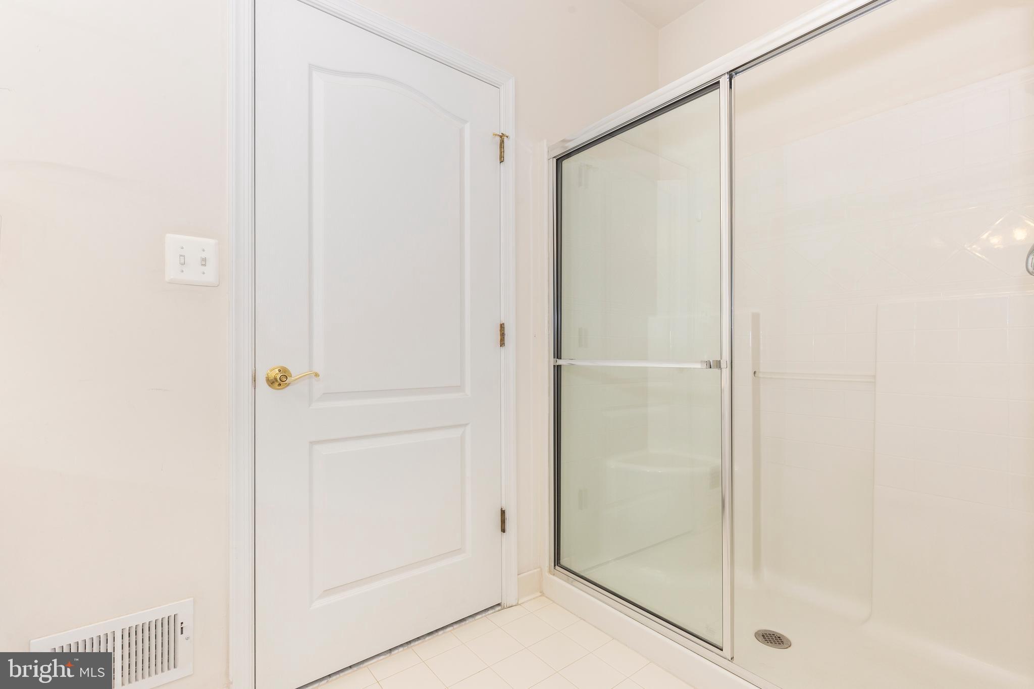 172 Saddletop Drive, Unit 364 Taneytown, MD 21787 - Photo 29 of 38 a bathroom with a glass shower door