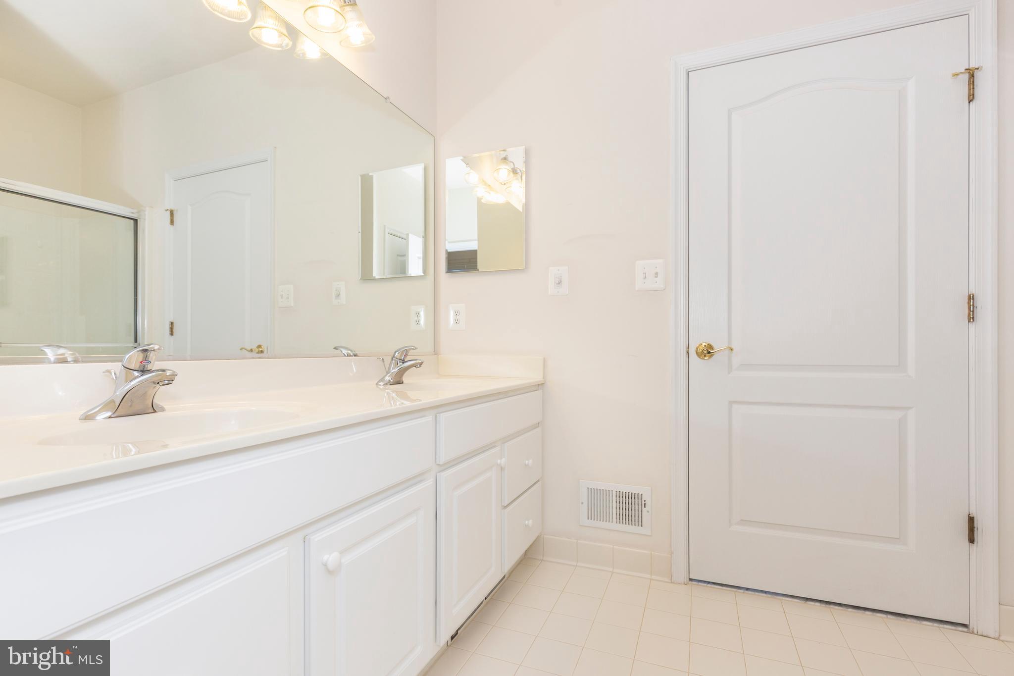172 Saddletop Drive, Unit 364 Taneytown, MD 21787 - Photo 31 of 38 a bathroom with a double vanity sink and a mirror