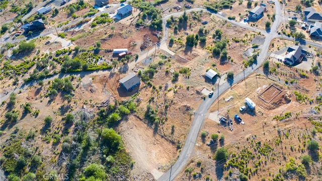 an aerial view of residential house with yard