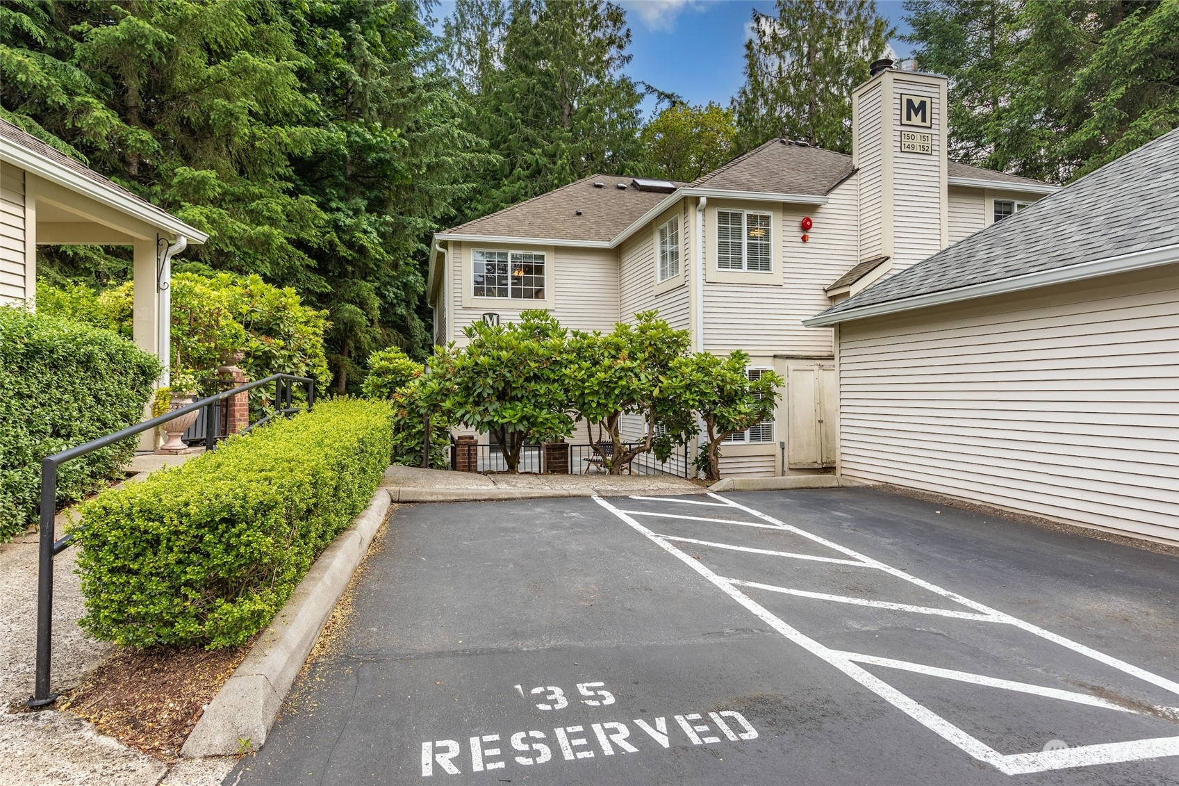 10909 Avondale Road Northeast, Unit M149 Redmond, WA 98052 - Photo 19 of 22 a view of a white house with a small yard and plants