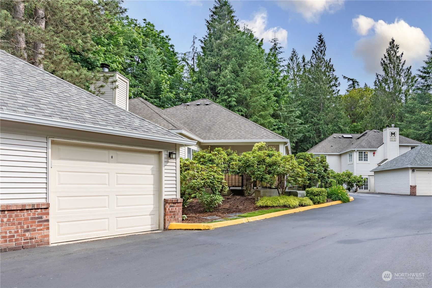 10909 Avondale Road Northeast, Unit M149 Redmond, WA 98052 - Photo 21 of 22 a view of a house with a yard and plants