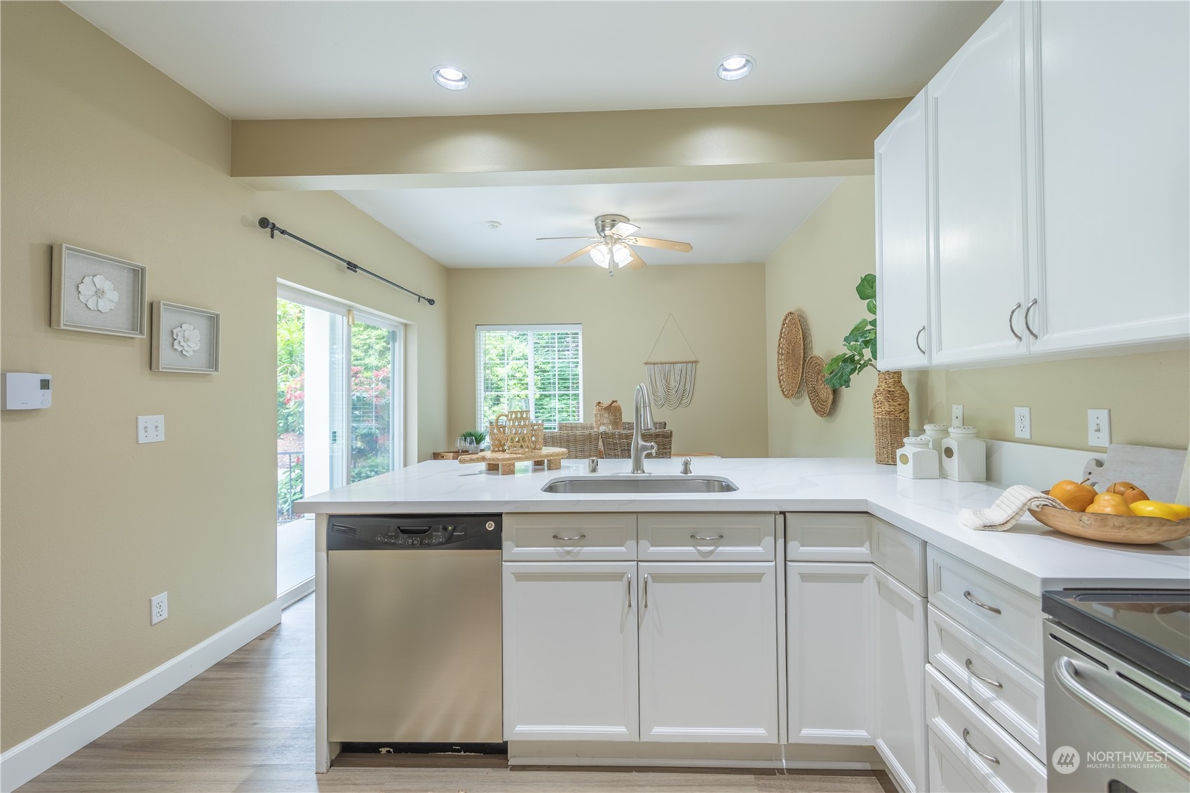 10909 Avondale Road Northeast, Unit M149 Redmond, WA 98052 - Photo 7 of 22 a kitchen with a sink cabinets and wooden floor