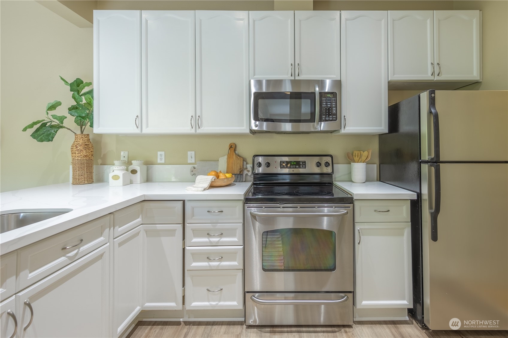 10909 Avondale Road Northeast, Unit M149 Redmond, WA 98052 - Photo 8 of 22 a kitchen with stainless steel appliances white cabinets and a stove