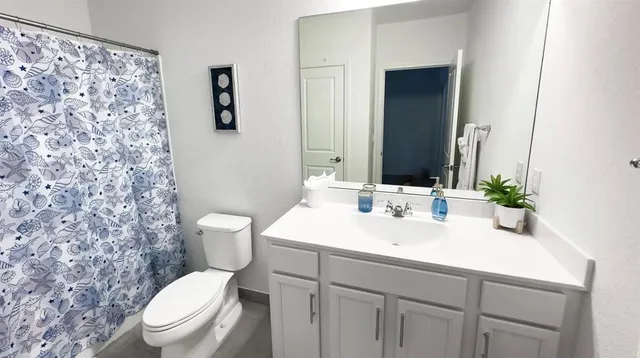 a bathroom with a sink a toilet and mirror