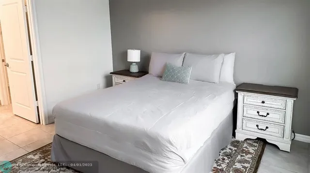 a bedroom with a bed and a mirror