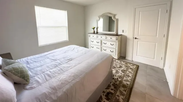 a bedroom with a bed and a window