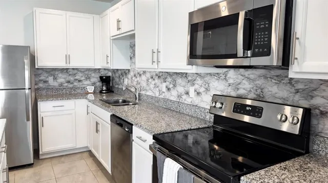 a kitchen with a stove microwave and sink