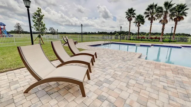swimming pool view with a lake view