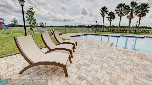 swimming pool view with a lake view