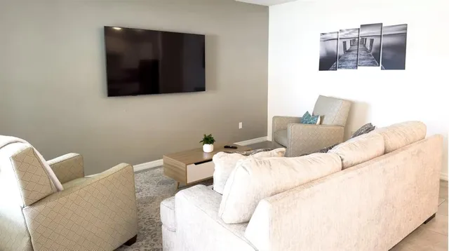 a living room with furniture and a flat screen tv
