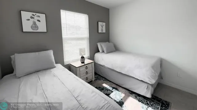 a bedroom with bed and a window