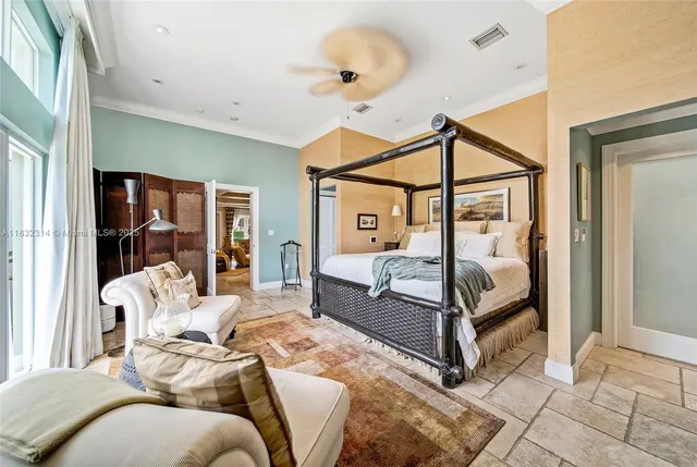 a bedroom with a bed and large window