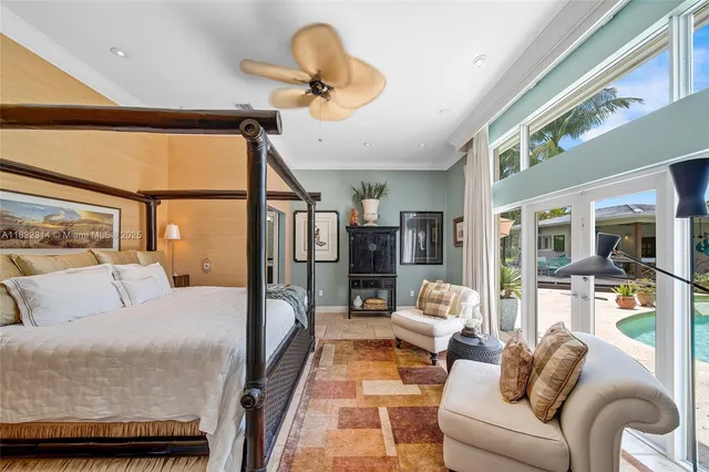 a bedroom with furniture and a large window