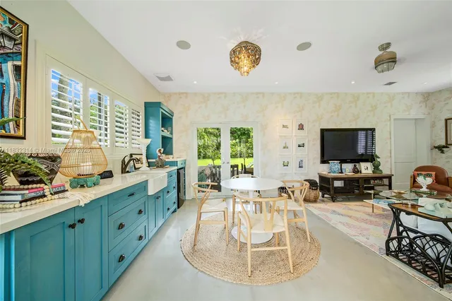 a kitchen with a large window and a view of living room