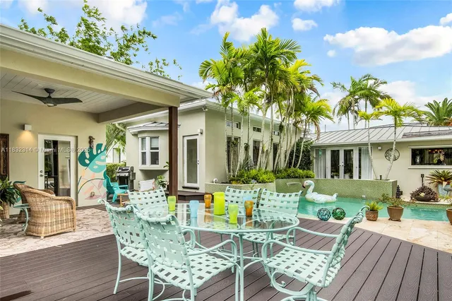 a view of a patio with table and chairs and potted plants