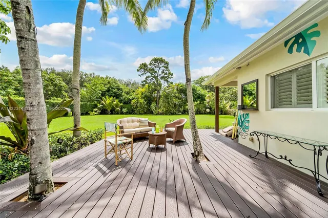 a view of balcony with chairs and wooden floor