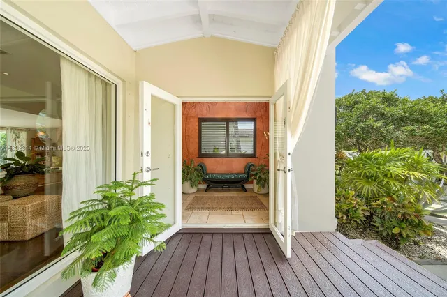 a view of front door and porch with wooden floor