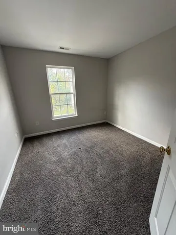 a bathroom with a tub a sink and mirror