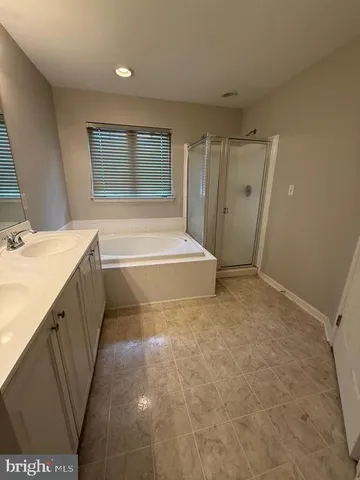 a bathroom with a sink a mirror and a bathtub