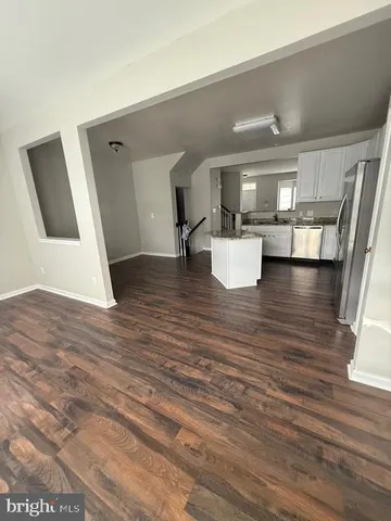 a kitchen with stainless steel appliances kitchen island granite countertop a stove a sink and a microwave