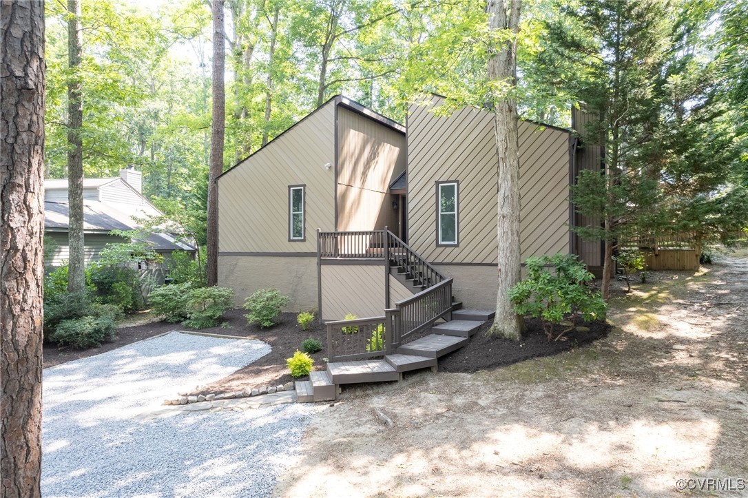 a backyard of a house with table and chairs