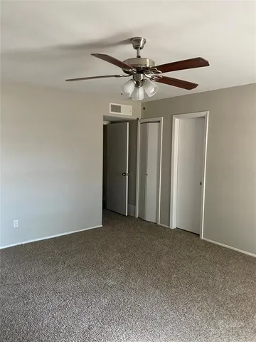 a view of a livingroom with a ceiling fan and window