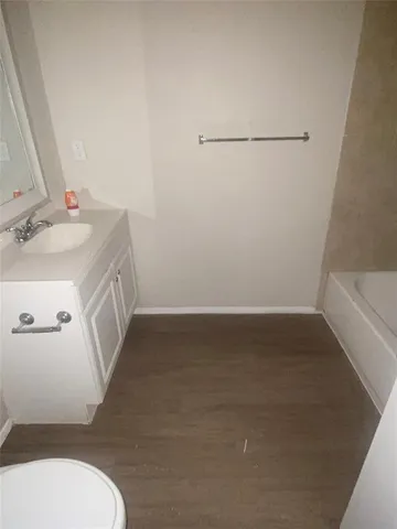 a bathroom with a sink a toilet and vanity