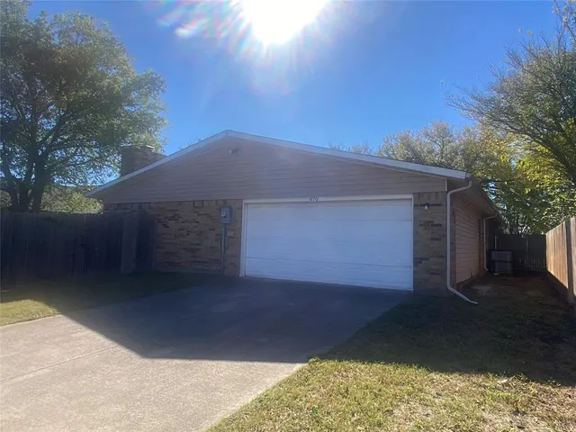 a backyard of house with garage