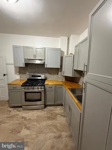 a kitchen with a stove a sink and a refrigerator