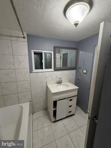 a utility room with a sink a mirror and shower