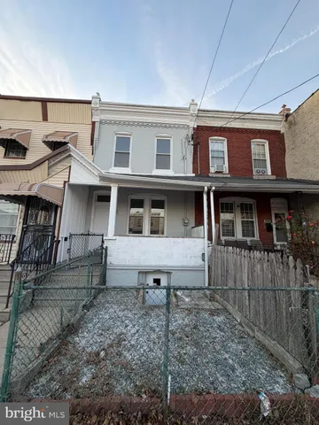 a view of a brick house with many windows