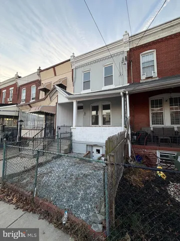 a view of a house with a yard and sitting space