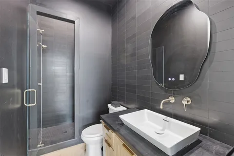 a bathroom with a sink toilet and shower