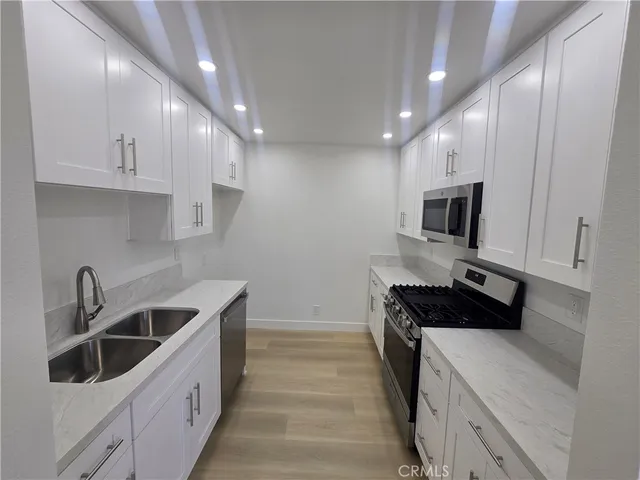 a kitchen with a sink and cabinets