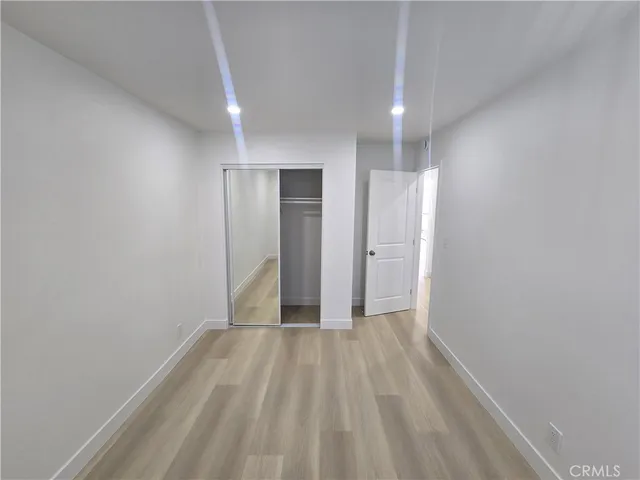 a view of hallway with wooden floor