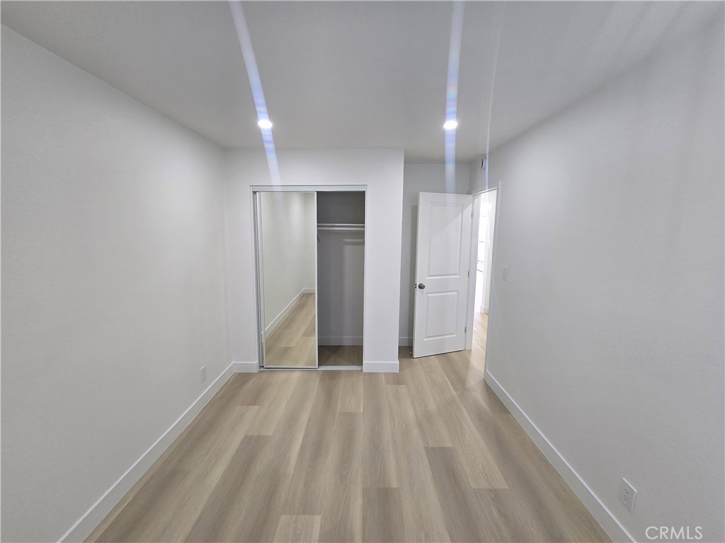 219 15th Street, Unit 12 Huntington Beach, CA 92648 - Photo 11 of 16 a view of hallway with wooden floor